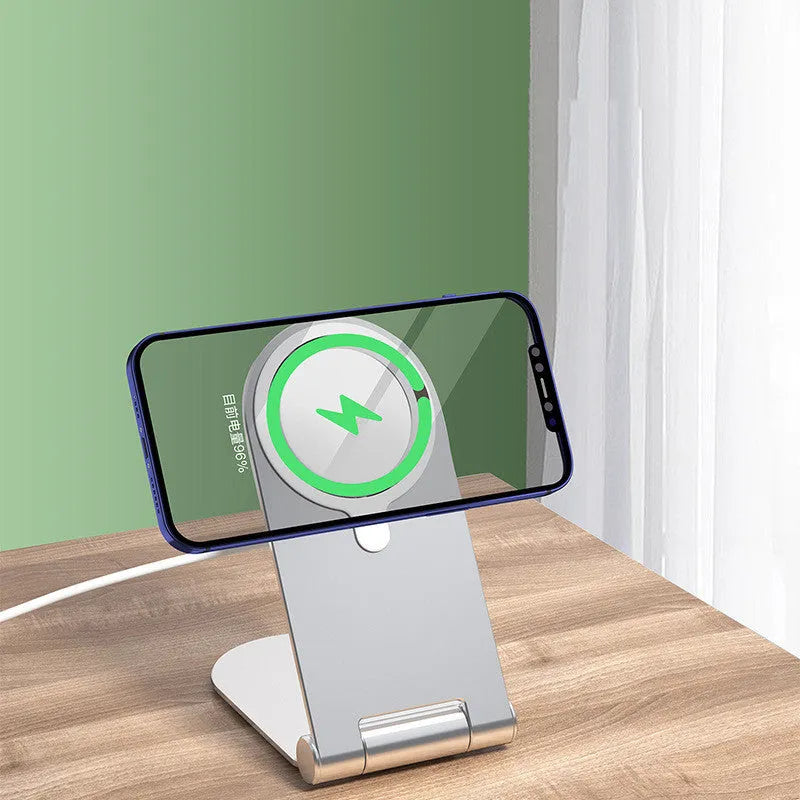 Silver vertical adjustable magnetic phone bracket for iPhone 12 on a car dashboard.