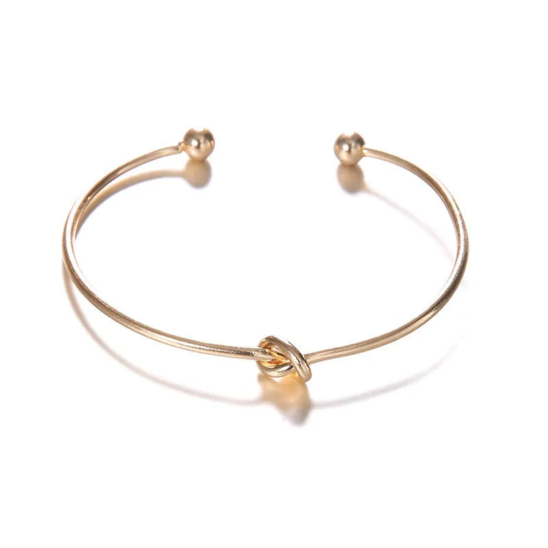 Gold vintage arrow knotted cuff bracelet for women with electroplated alloy construction