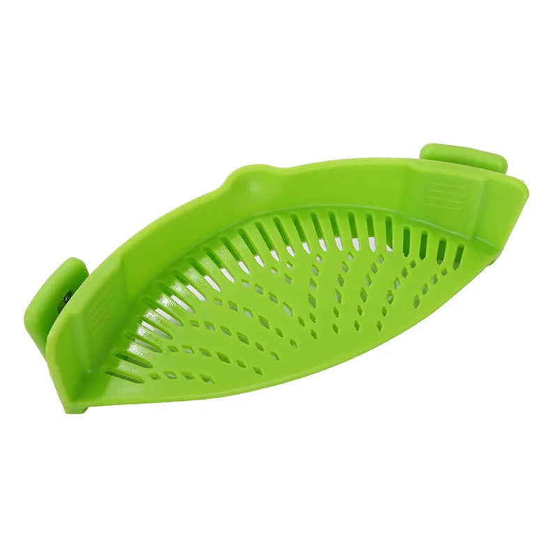 Silicone clip-on colander strainer in black with stainless steel clip attached to a pot rim for draining liquid
