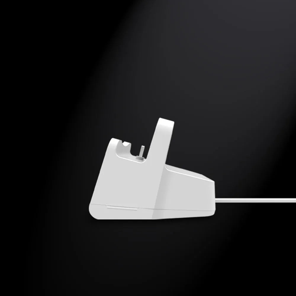 White plastic headphone charging base for wireless earbuds on desk