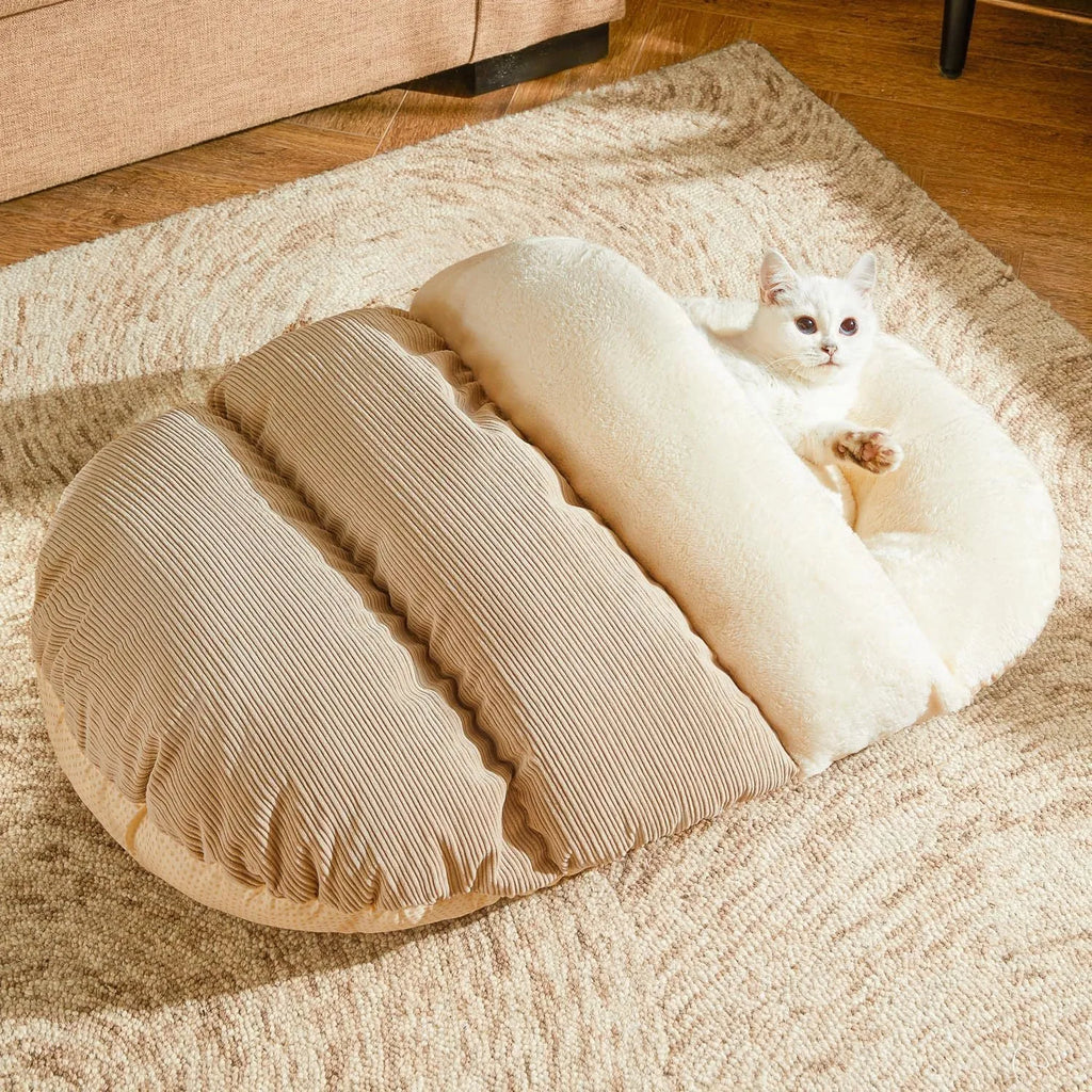 Grey slipper-shaped cat cave bed with plush lining on a wooden floor.
