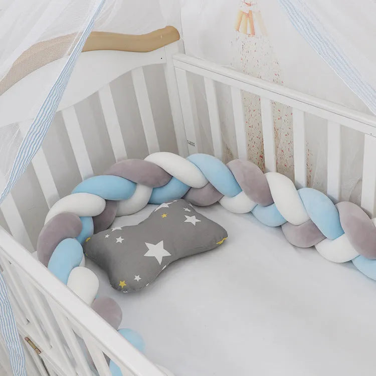 Long, flexible baby crib bumper pillow in spandex velvet, shown fitted around a white cot for safety protection.
