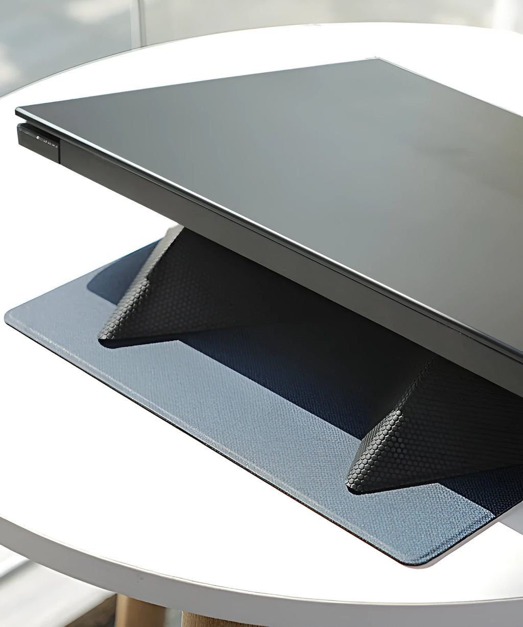 Blue foldable laptop cooling bracket shown open and closed, with an ergonomic viewing angle.