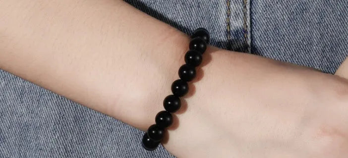Women's geometric black agate bracelet with elastic cord, shown in 8mm bead size.