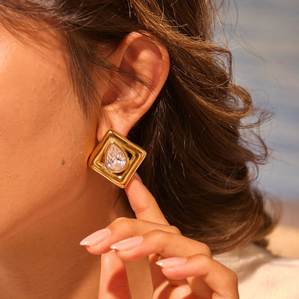 Gold geometric water drop design stud earrings with zircon accents on stainless steel