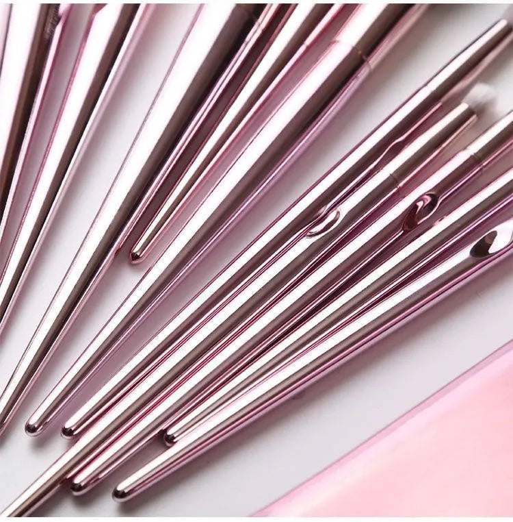 Pink PVC makeup brush set with non-slip grip handle and soft bristles on a light background