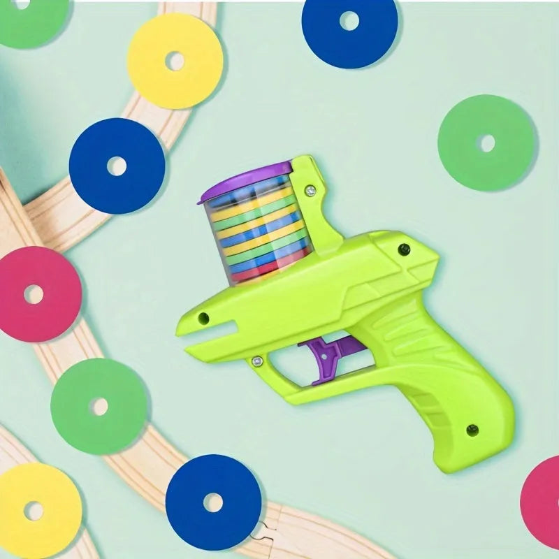 Green and purple battery-free interactive cat toy launcher with soft foam discs on a plain background