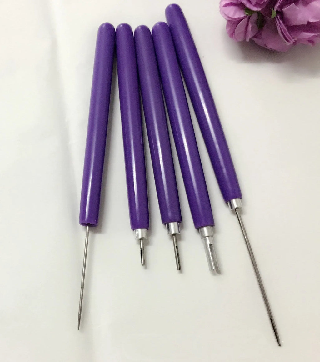 Purple quilling paper tool set with five slotted pens and needle stylus on white background