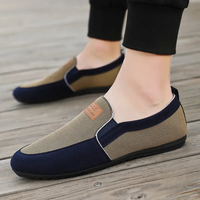 Men's grey canvas casual board shoes with round toe design and rubber soles shown from side view