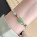 Green jade and copper ethnic bracelet with peace buckle centrepiece and double ring design