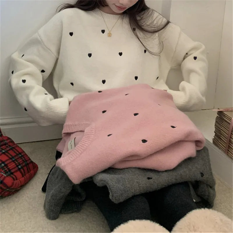 Women's loose beige acrylic pullover sweater with embroidered red love heart design on the chest.