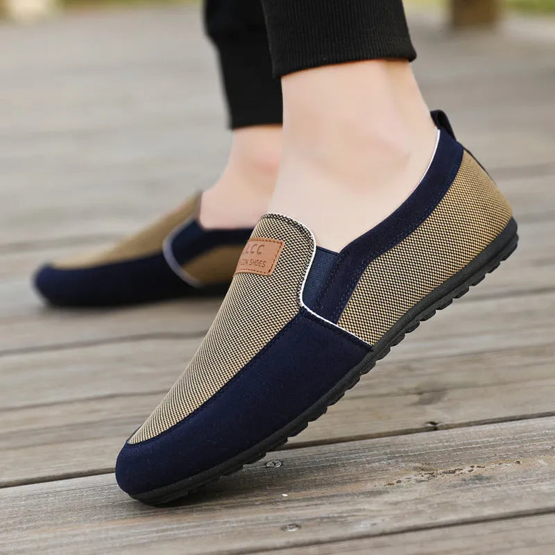 Men's grey canvas casual board shoes with round toe design and rubber soles shown from side view