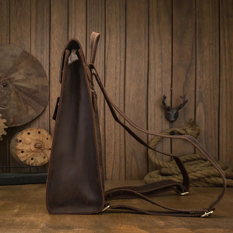 Dark brown genuine leather men's travel bag with shoulder straps and top handle.
