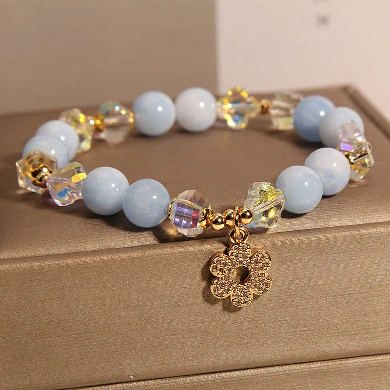 Women's aquamarine crystal bracelet with four-leaf clover design and a pearl accent.