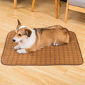 Brown rattan cooling mat for dogs on a wooden floor, showing woven texture.