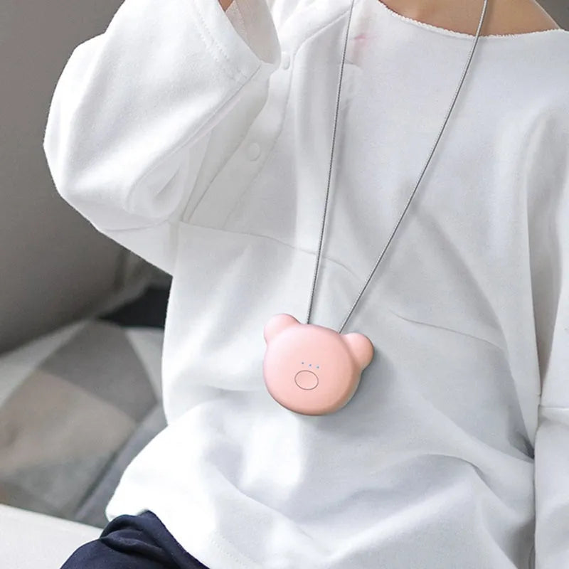 Mini USB portable air purifier necklace in blue, shown worn and with USB cable.