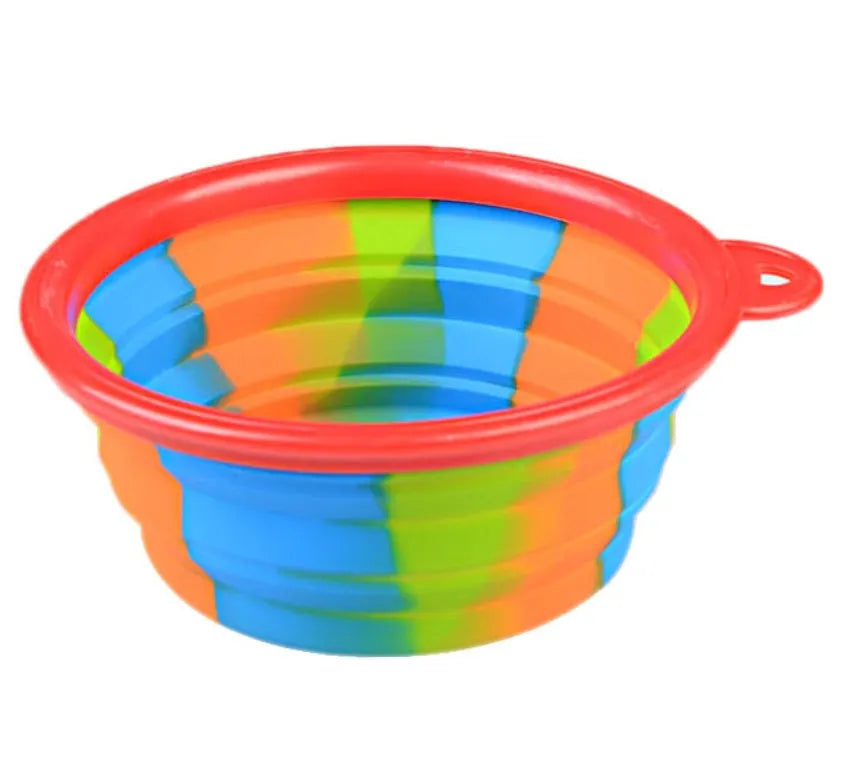 Collapsible silicone dog bowl in camouflage pattern folded flat on green surface
