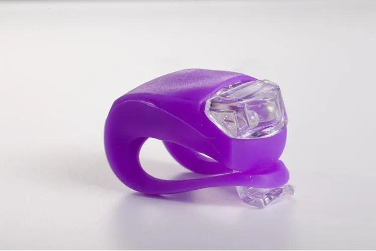 LED bike safety light with clip, flexible silicone body, and three light modes for cycling and outdoor use.