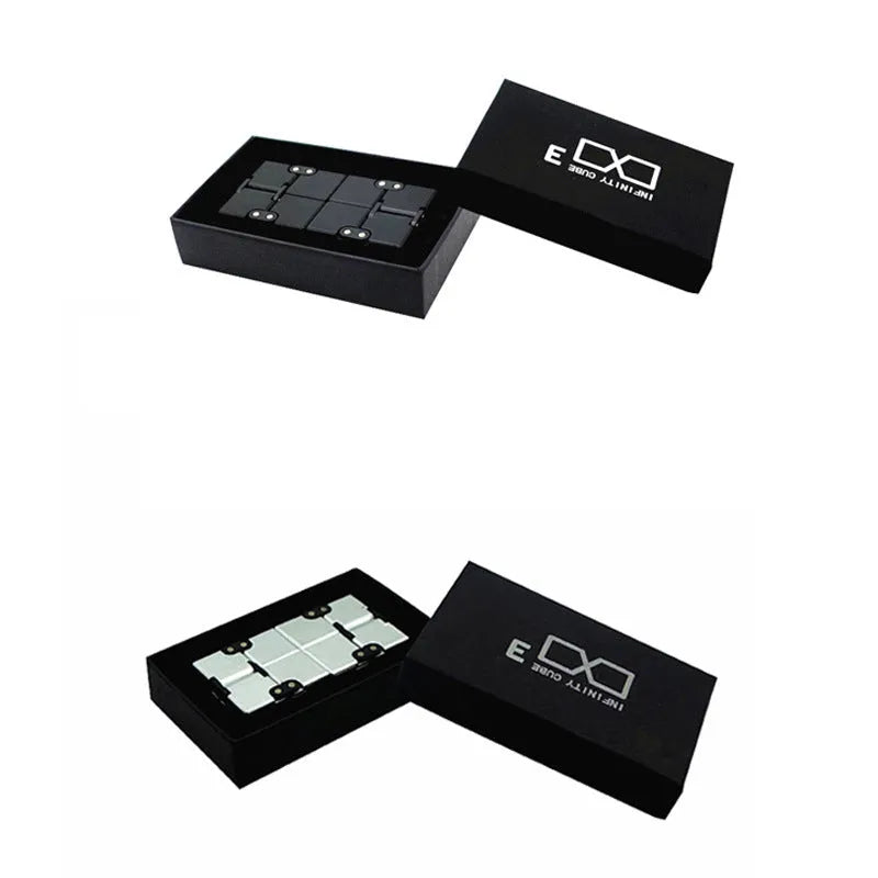 Zinc alloy infinity cube fidget toy showing black and silver rotating cube puzzle on a desk.