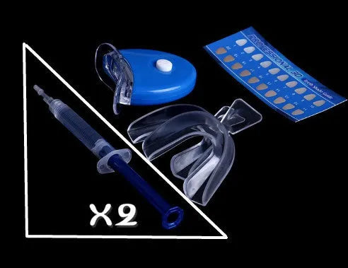 Bright Teeth Whitening Kit with LED cold light device and desensitizing gel syringes on a white background