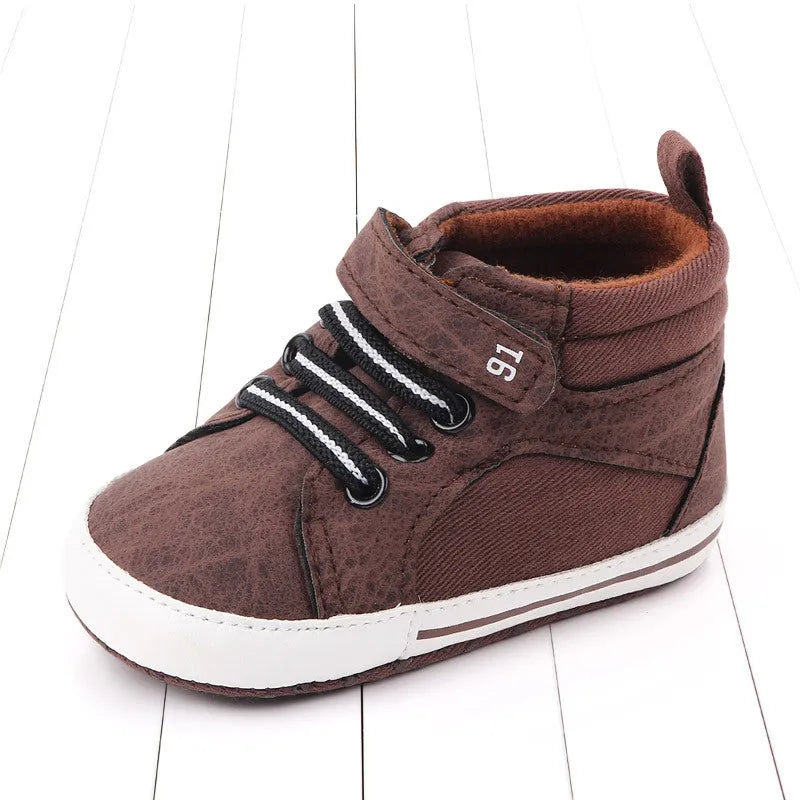 Blue cotton high-top toddler shoes with velcro strap for boys on white background