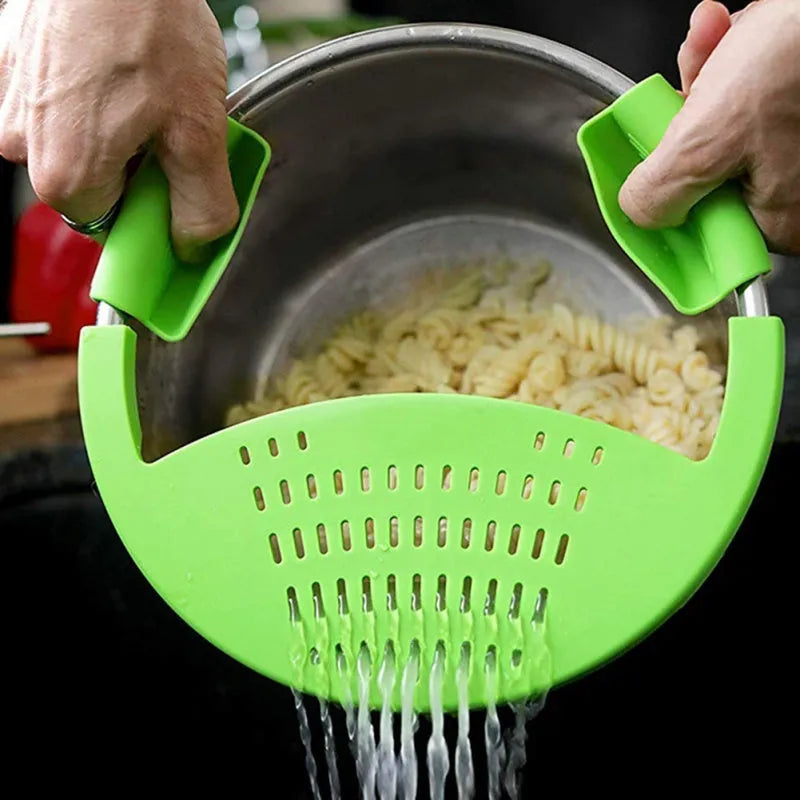 Black silicone food oil drainer clipped onto a pressure cooker liner for draining liquid