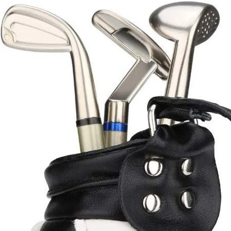 Carved PU leather and alloy golf bag pen holder in blue on a desk