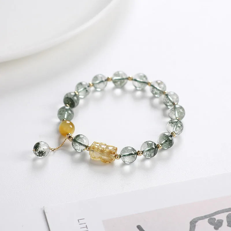 Green Phantom Quartz bracelet with gold rutile patterns in geometric 8mm beads