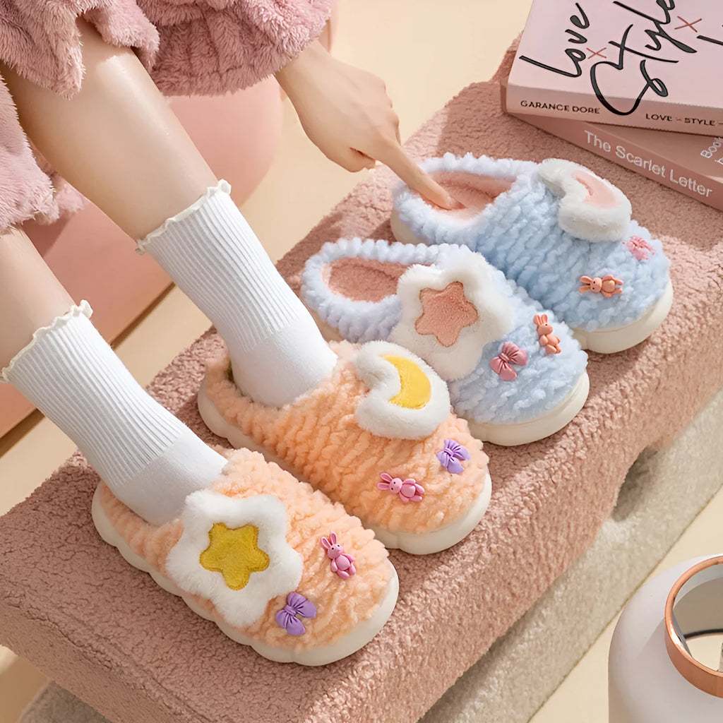 Women's light blue cartoon fleece-lined plush slippers with floral pattern and round toe.