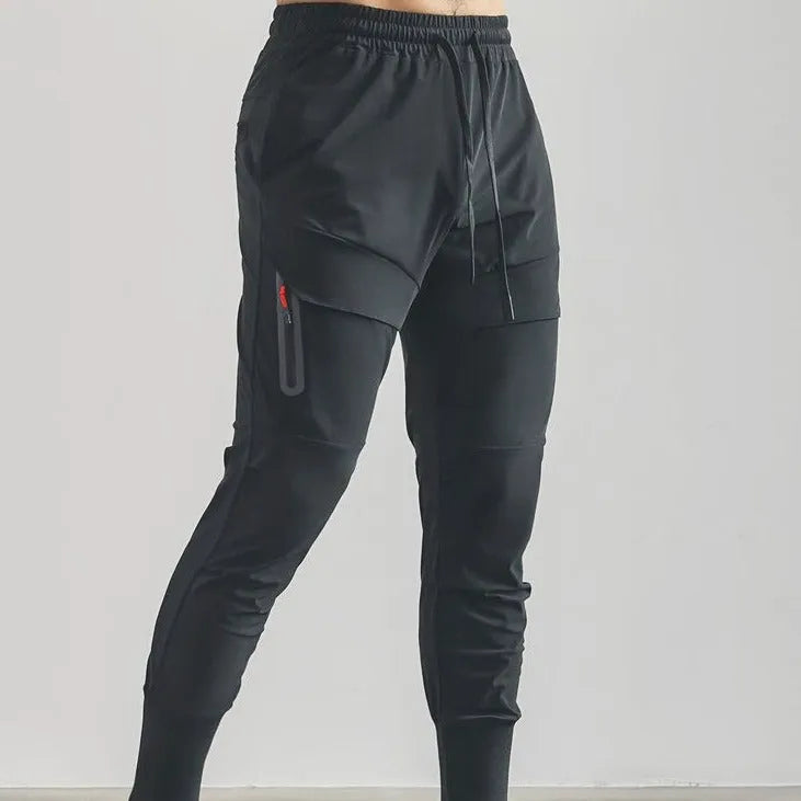 Men's solid colour polyester jogger pants in black, mid-waist micro-elasticity sports trousers for autumn leisure.