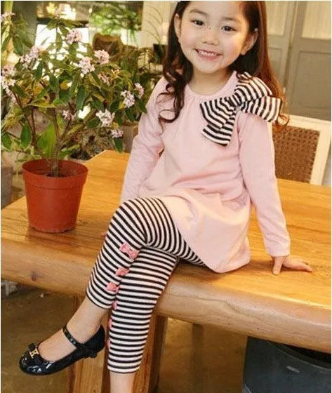Pink cotton two-piece clothing set for a girl, showing the matching top and bottom.