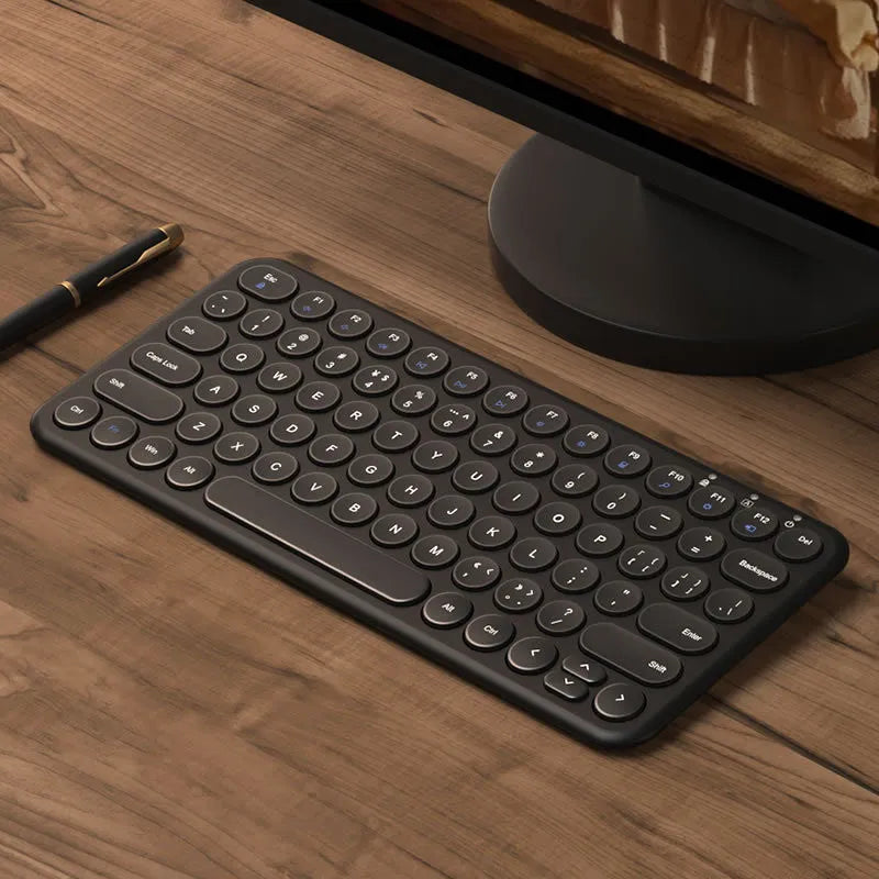 Mute brand ultra-thin wireless keyboard and mouse set with USB receiver on a wooden desk.