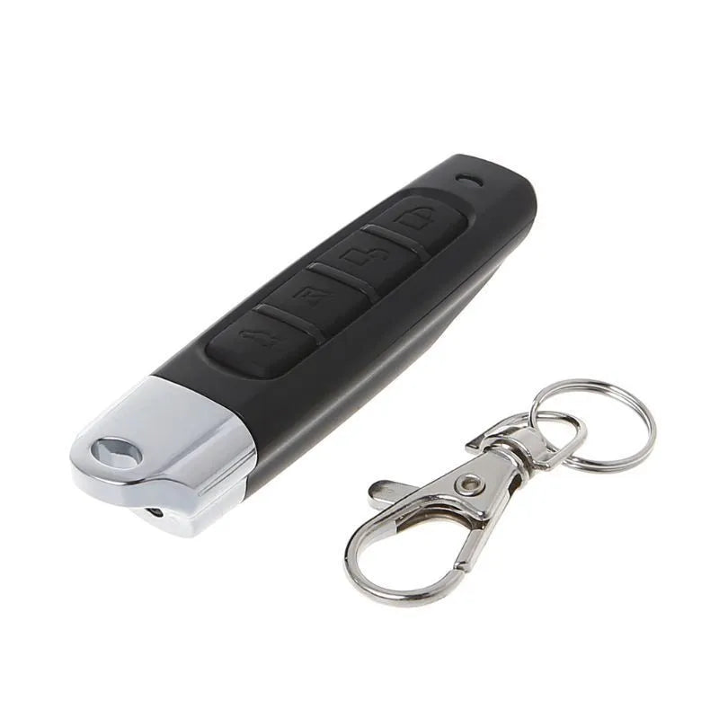 A compact black rolling door remote control showing buttons for copying and testing signals.