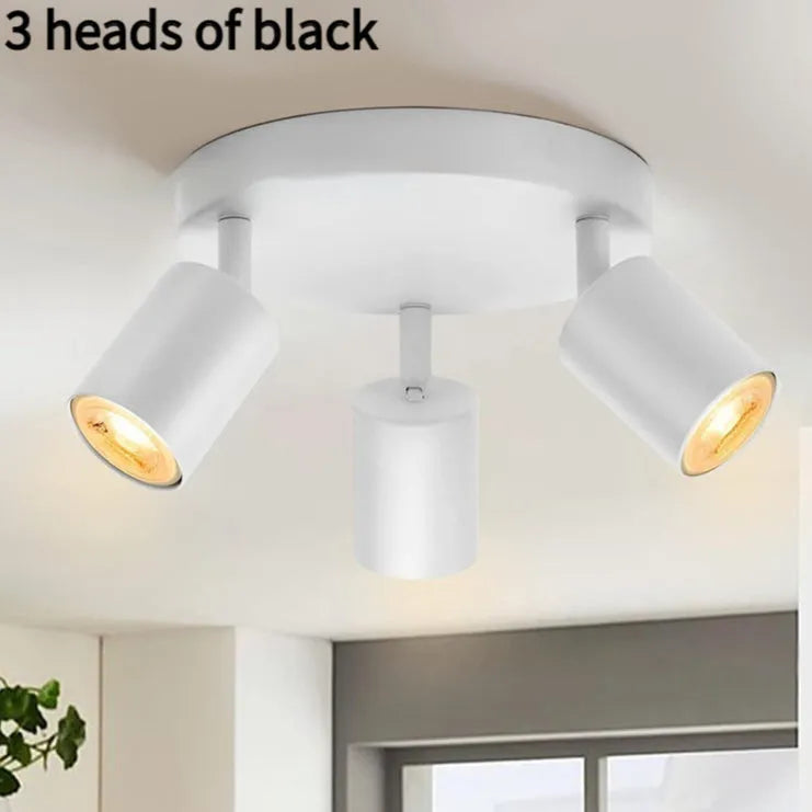 Three-head adjustable aluminium ceiling spotlight in black finish, angled for TV wall lighting