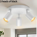 Three-head adjustable aluminium ceiling spotlight in black finish, angled for TV wall lighting