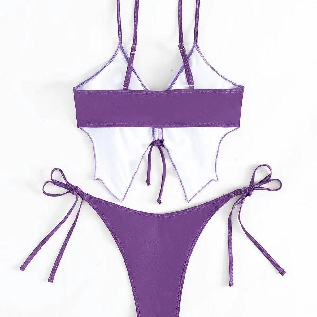 Women's purple bow ins style split bikini suit top and briefs on a mannequin.