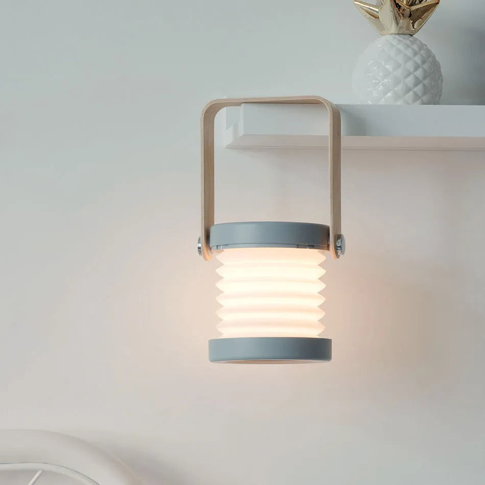 Foldable touch dimmable LED night light in white showing table lamp and lantern positions
