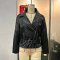 Black punk style short jacket with a Peter Pan collar, leather lapel trim, and a visible drawstring at the waist.