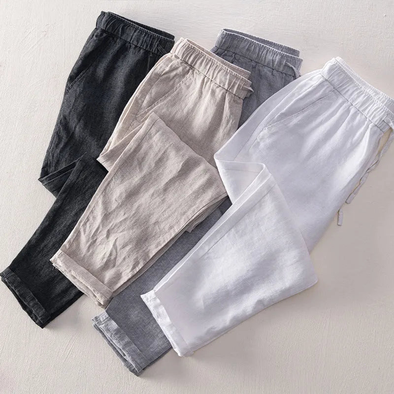 Men's straight-leg linen trousers in light grey colour showing mid-waist and straight-leg cut