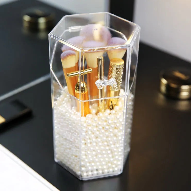 Transparent acrylic makeup brush storage bucket in solid colour plastic on bedroom countertop
