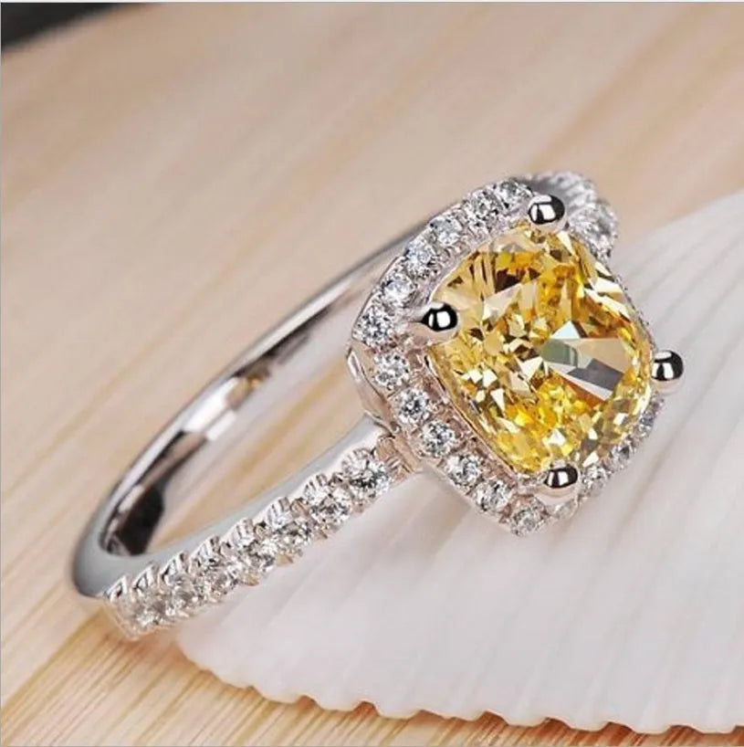 Silver alloy women's ring with artificial gemstone geometric design on white background