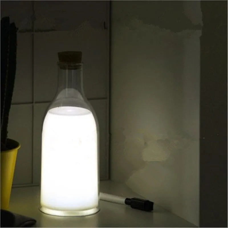 White milk bottle shaped LED nightlight on a wooden surface, USB rechargeable, with a 30-minute timer and DIY message panel