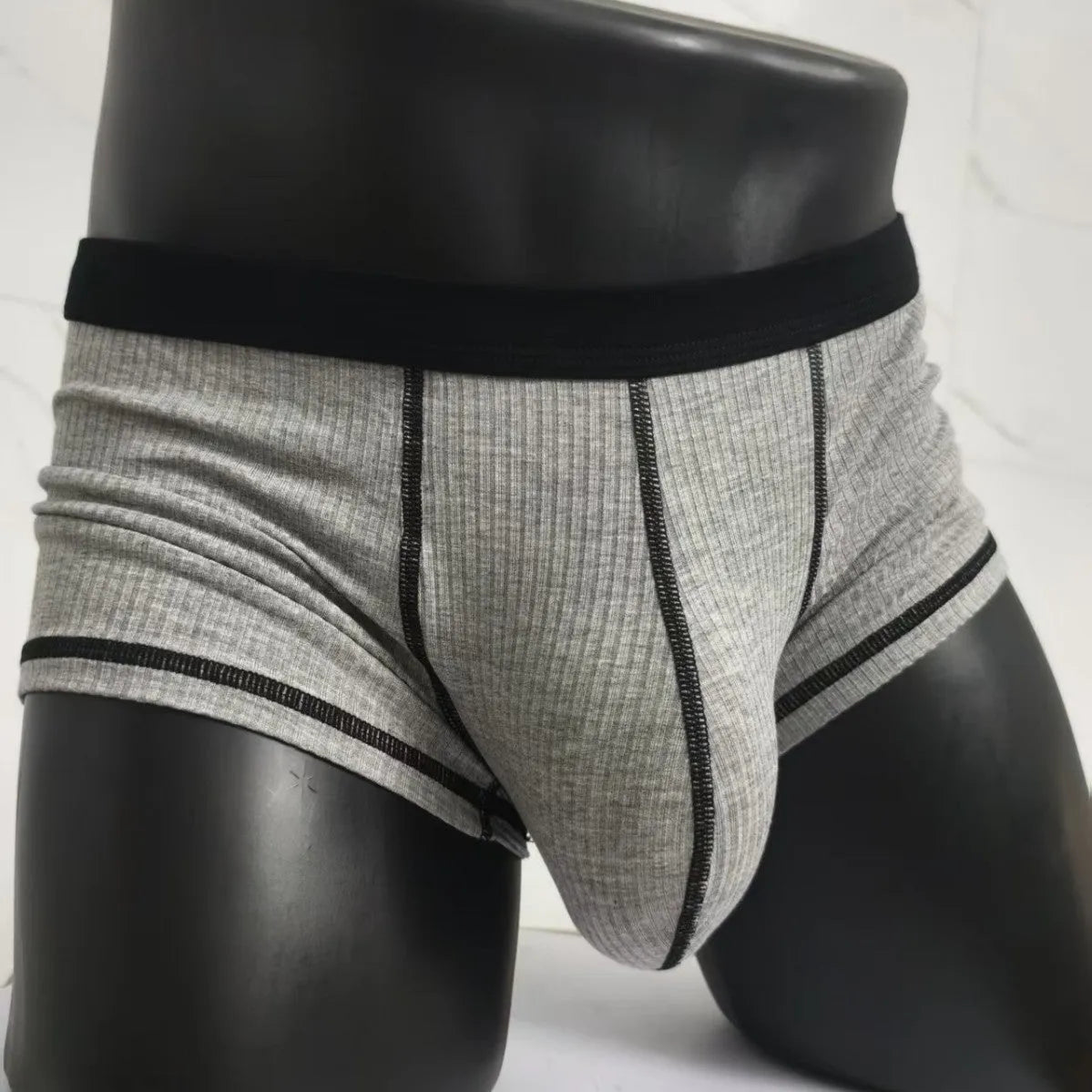Men's solid colour breathable boxer shorts in Army Green, shown laid flat to display thin fabric and cut.