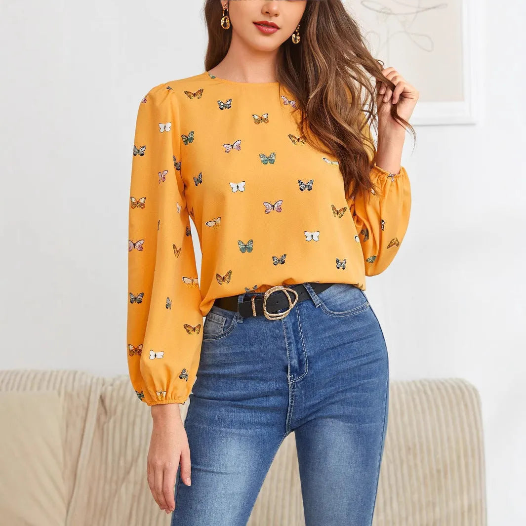 Women's green long-sleeved loose shirt with butterfly print pattern.