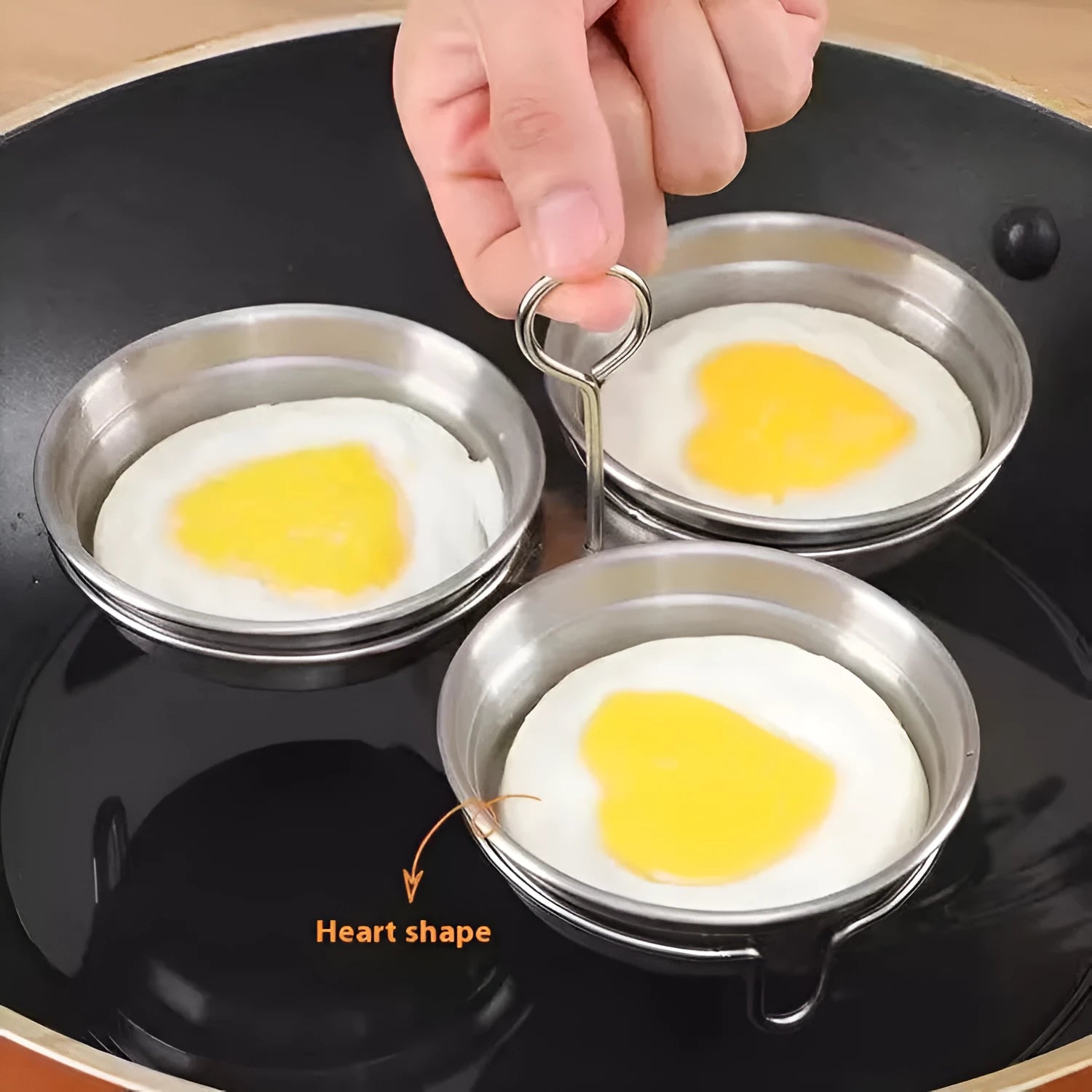 Mini stainless steel egg steamer for creating heart-shaped and round boiled eggs.