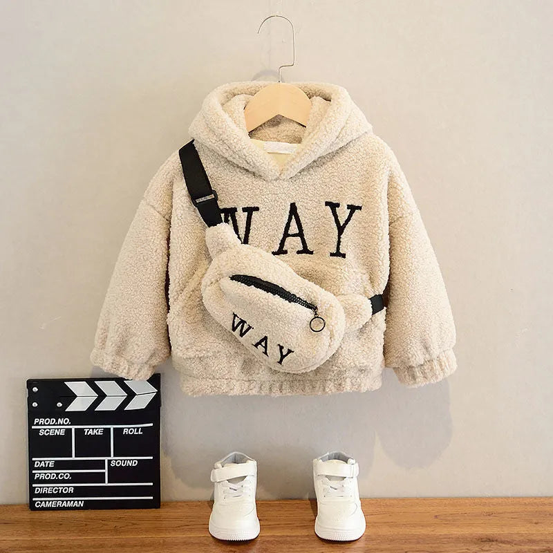 Child wearing a beige cashmere fleece hooded jacket with a cartoon pattern on the front.