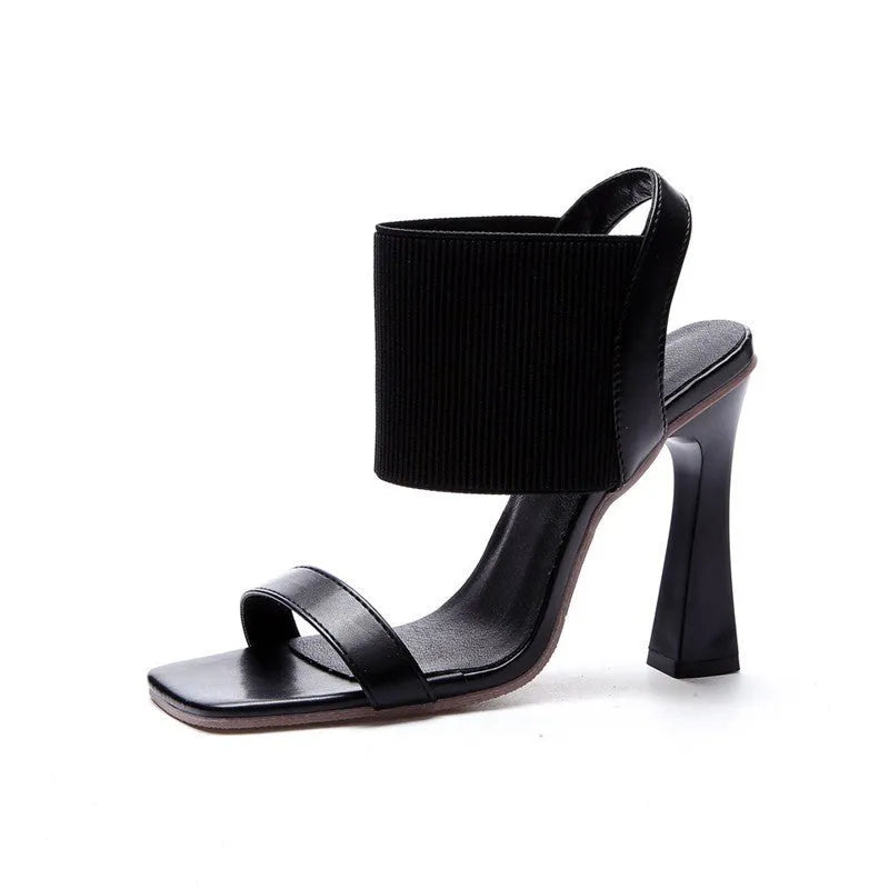 Women's black high heel sandals with an elastic strap across the foot and a rubber sole