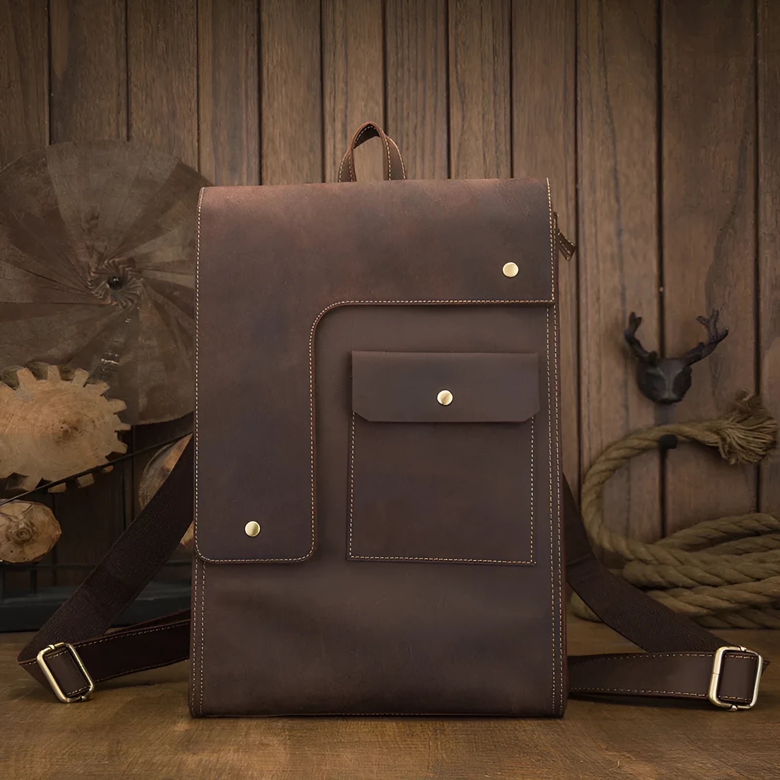 Dark brown genuine leather men's travel bag with shoulder straps and top handle.