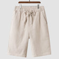 Men's loose fit linen shorts in beige with elasticated waist and cropped length