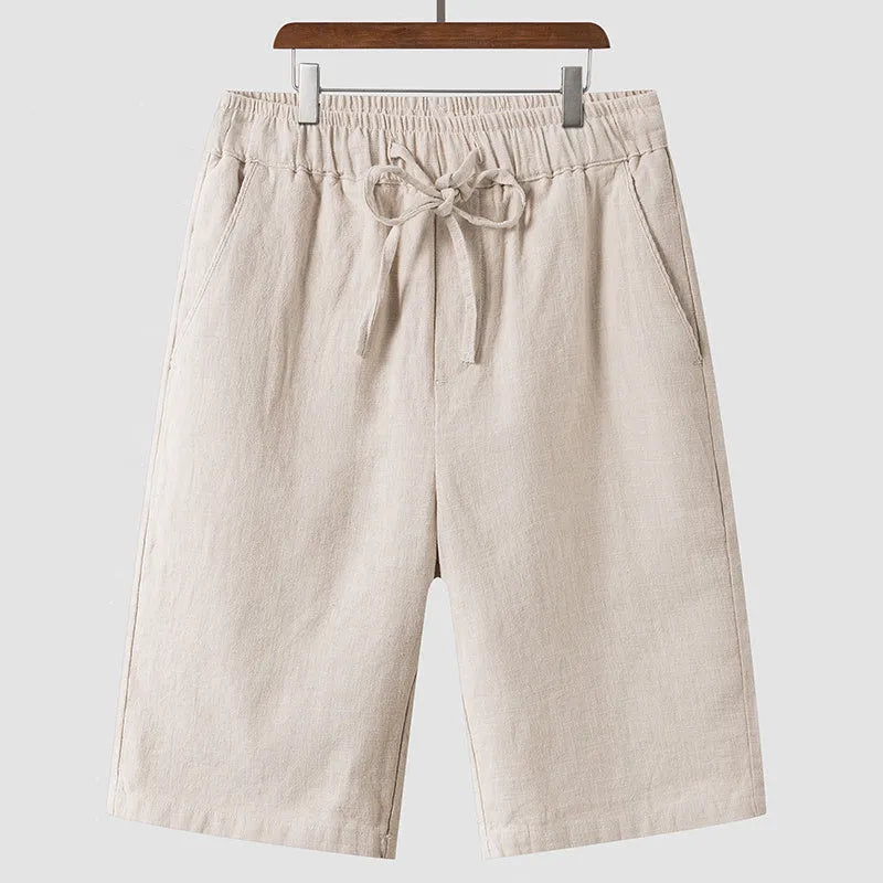 Men's loose fit linen shorts in beige with elasticated waist and cropped length